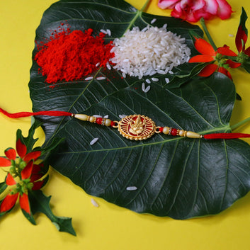 Traditional Ganesha Rakhi With Golden Finish And Sacred Red Thread Wukusy