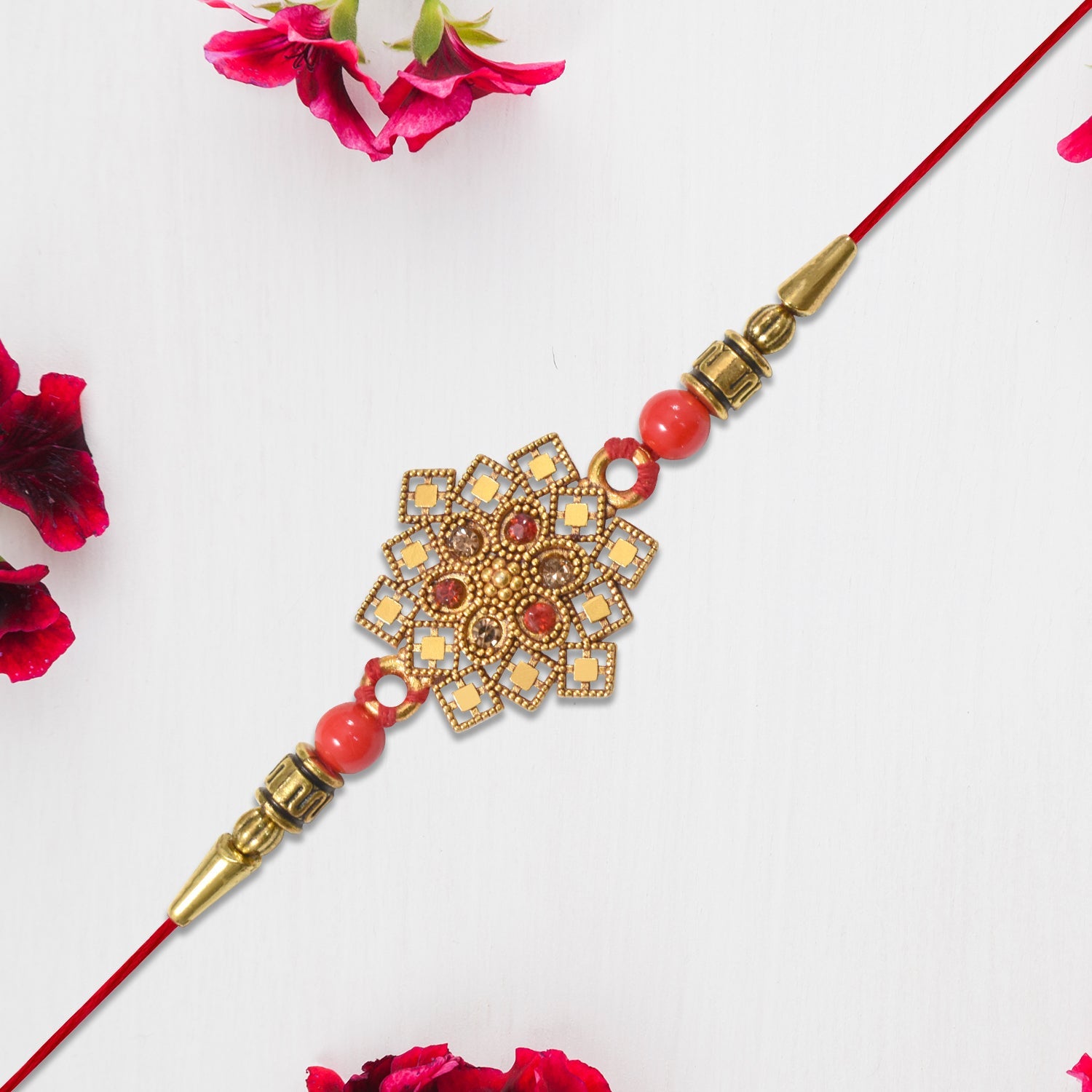 Traditional Golden Floral Rakhi With Intricate Design And Red Beads On Red Thread Wukusy