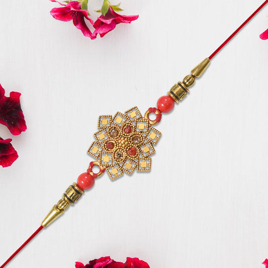 Traditional Golden Floral Rakhi With Intricate Design And Red Beads On Red Thread Wukusy