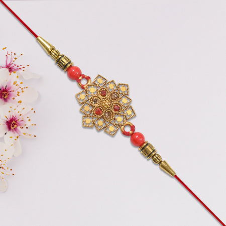 Traditional Golden Floral Rakhi With Intricate Design And Red Beads On Red Thread Wukusy