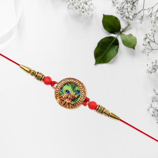 Traditional Krishna Rakhi With Peacock Feather Design And Decorative Beads On Red Thread Wukusy