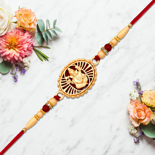Traditional Ganesha Rakhi With Golden Finish And Sacred Red Thread Wukusy
