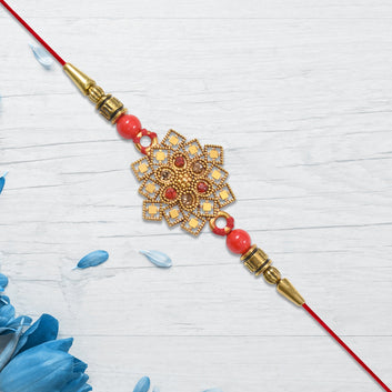 Traditional Golden Floral Rakhi With Intricate Design And Red Beads On Red Thread Wukusy