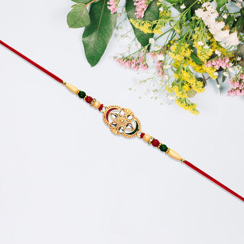 Traditional Oval Rakhi With Kundan Work And Red-green Beads Wukusy