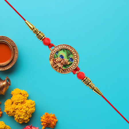 Traditional Krishna Rakhi With Peacock Feather Design And Decorative Beads On Red Thread Wukusy
