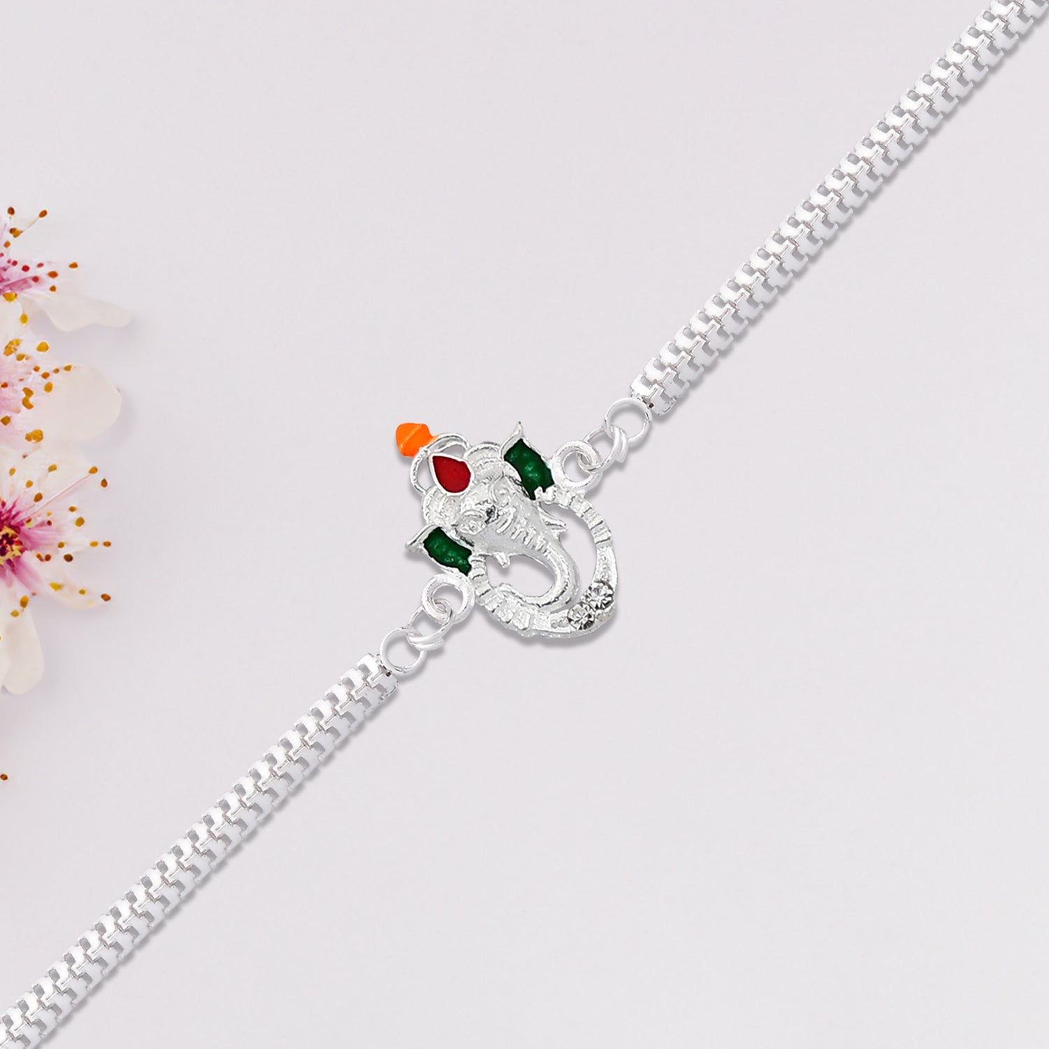 Stylish Ganesha Rakhi With Enamel Highlights And Silver Metal Chain Wukusy