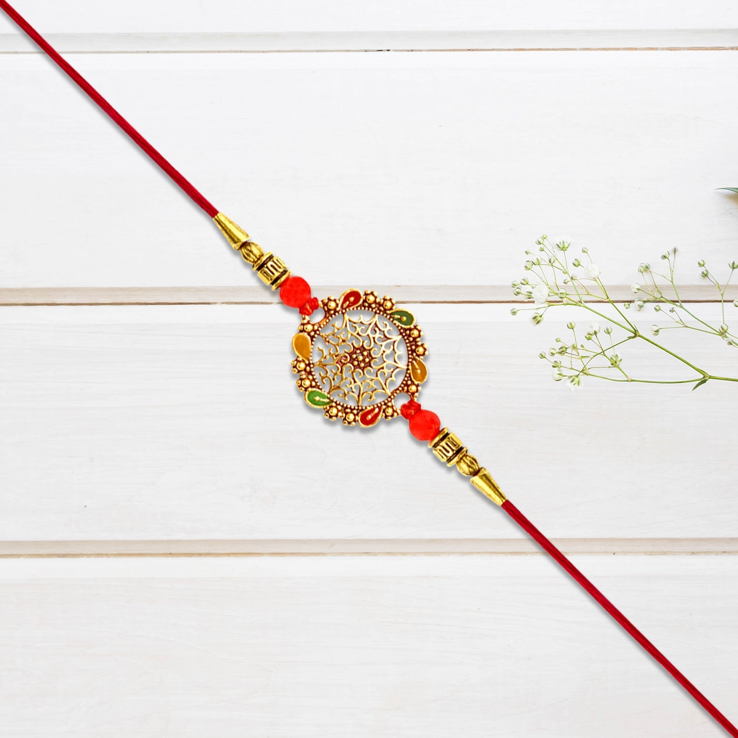 Intricately Designed Circular Rakhi With Multicolor Accents And Red Thread For Rakshabandhan Wukusy