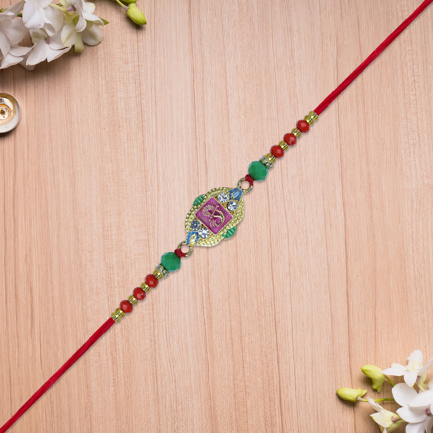 Om Rakhi With Decorative Beads And Stone Work Wukusy