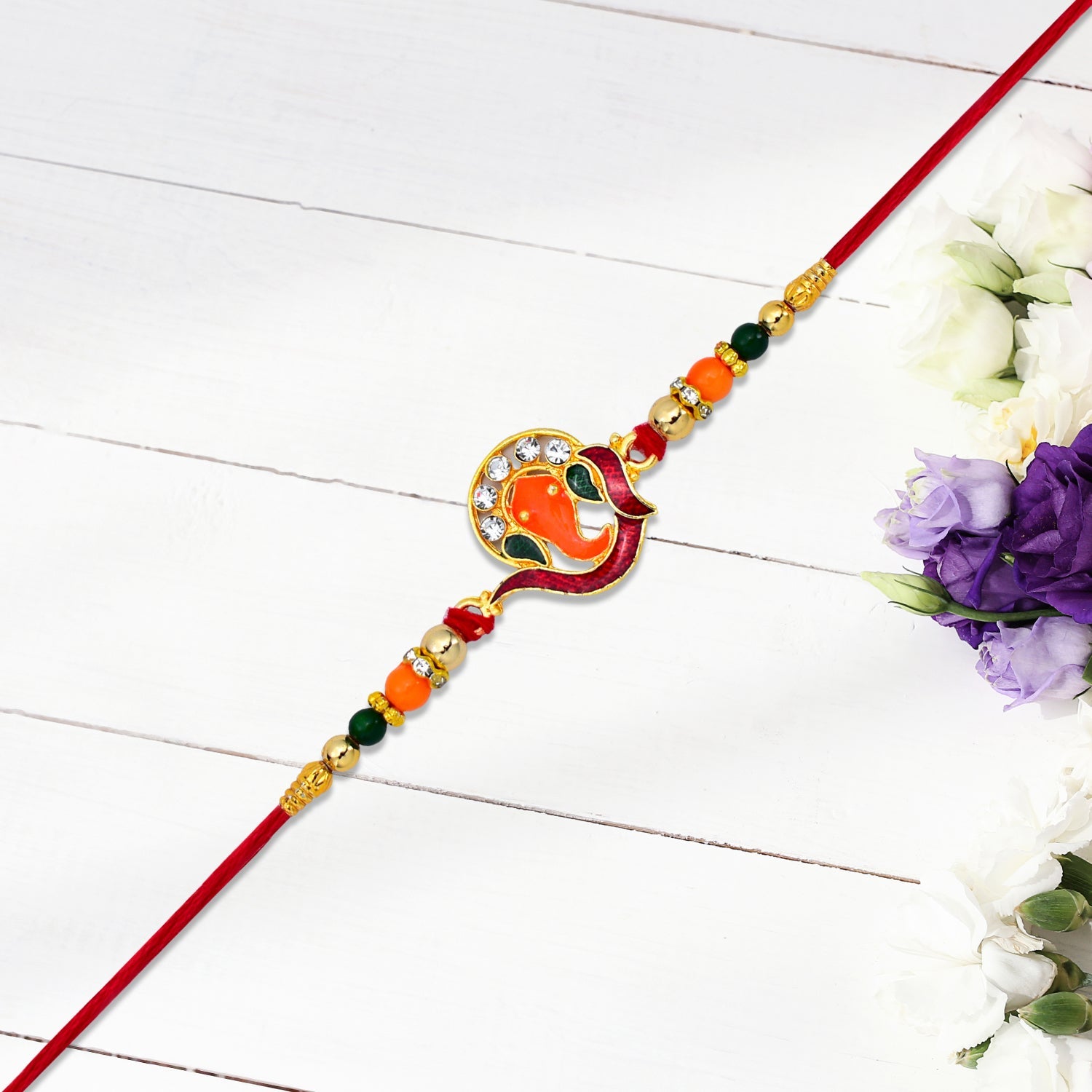 Golden Ganesha Rakhi With Red-green Beads And Stone Detailing Wukusy