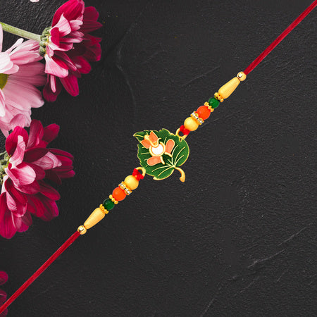 Green Tulsi Leaf Rakhi With Orange Enamel Flower And Beaded Thread Wukusy