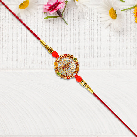 Intricately Designed Circular Rakhi With Multicolor Accents And Red Thread For Rakshabandhan Wukusy