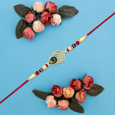 Peacock Feather Design Rakhi With Beaded Detailing And Red Thread Wukusy