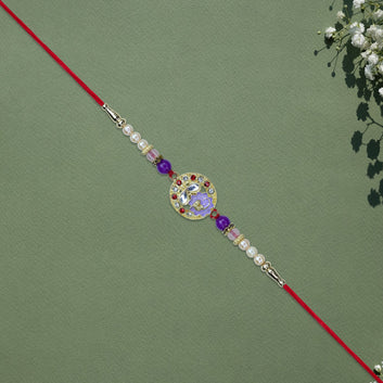 Elegant Ganesh Rakhi With Pearl And Purple Beads