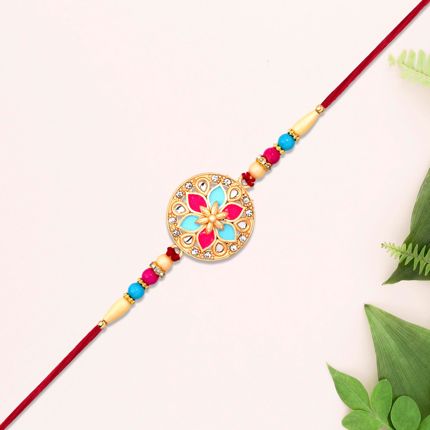 Round Floral Rakhi With Pink-blue Enamel And Beaded Thread Wukusy