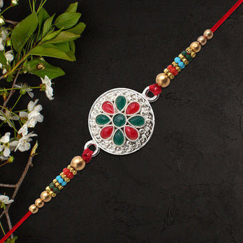 Silver Plated Floral Rakhi With Red  Green Stones