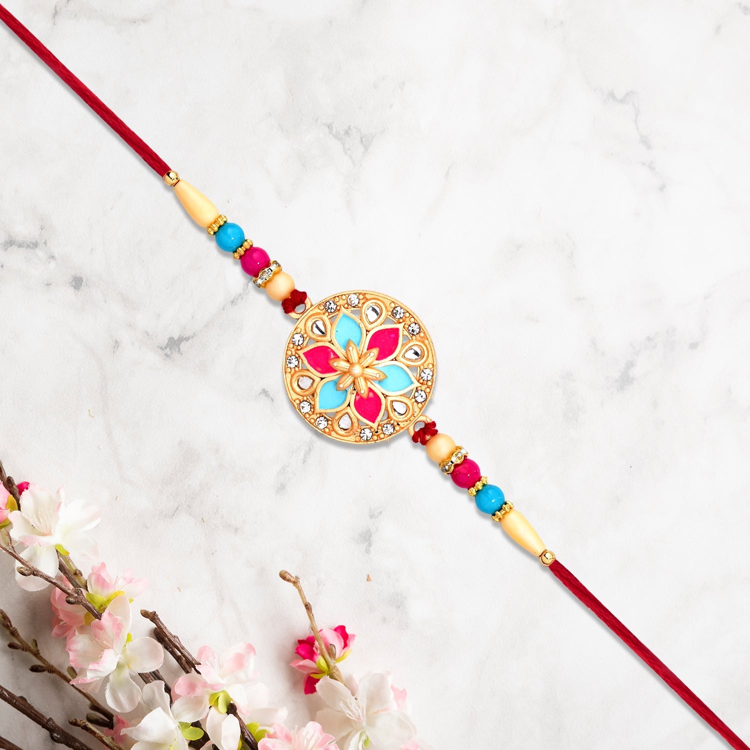 Round Floral Rakhi With Pink-blue Enamel And Beaded Thread Wukusy