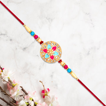 Round Floral Rakhi With Pink-blue Enamel And Beaded Thread Wukusy