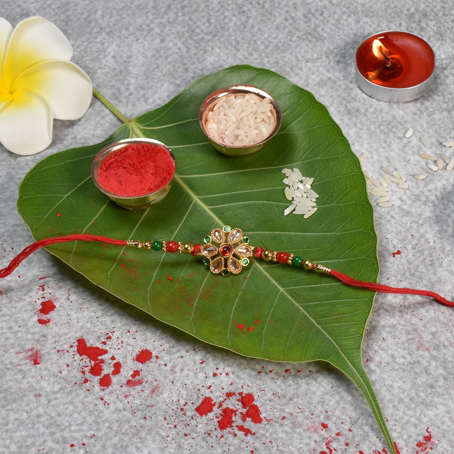 Floral Kundan Rakhi With Red-green Beads And Golden Finish Wukusy