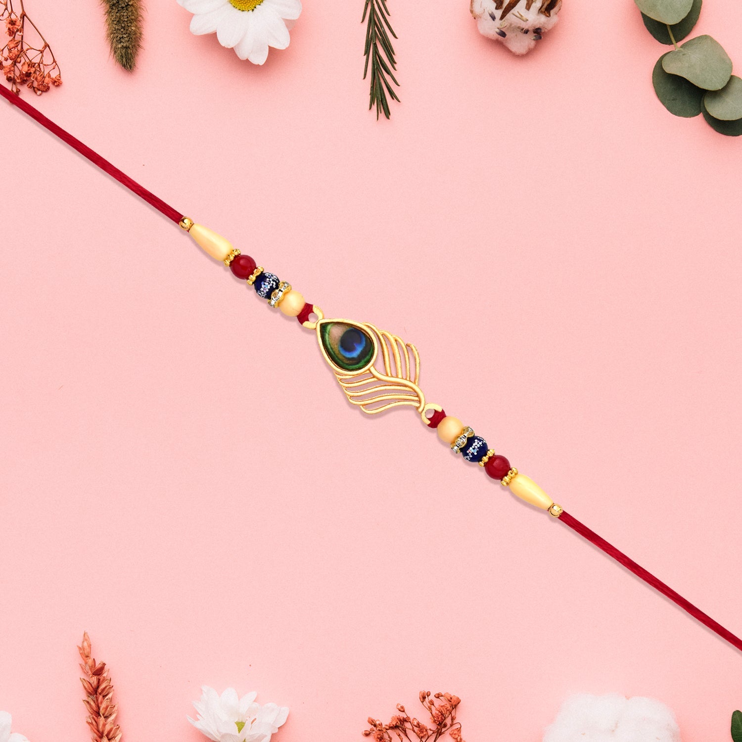 Peacock Feather Design Rakhi With Beaded Detailing And Red Thread Wukusy