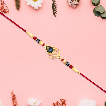 Peacock Feather Design Rakhi With Beaded Detailing And Red Thread Wukusy