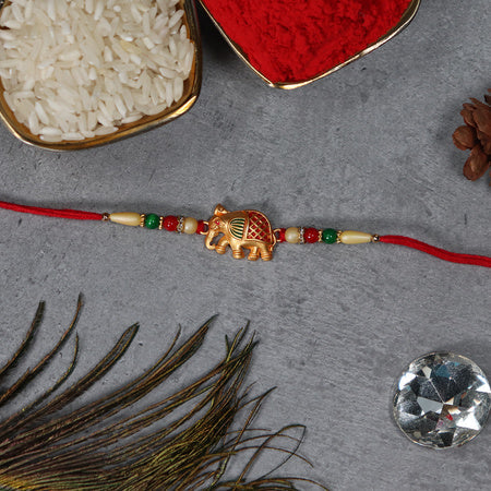 Golden Elephant Rakhi With Red Green Moti Wukusy